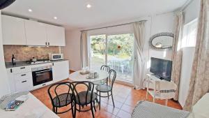 a kitchen and dining room with a table and chairs at 1 Sire - Llafranc in Calella de Palafrugell