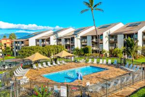 a swimming pool in front of a resort at Hale Kamaole in Wailea