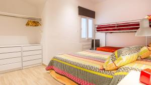 a bedroom with a bed and a dresser at 1 Sica - Llafranc in Llafranc