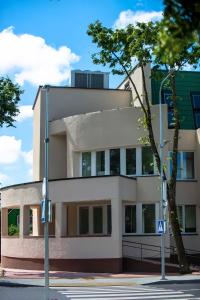 a building on the corner of a street at AVE MEDICA Apartments & SPA in Palanga
