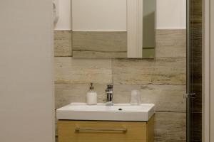a bathroom with a white sink and a mirror at MAROSTICANA 008 in Dueville