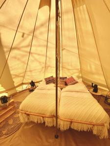利赫塔特的住宿－AMANI - Aap，帐篷内的一张床,