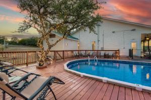a deck with a swimming pool on a house at Gorgeous 10 Acre Estate POOL HOT TUB GAME ROOM in Spicewood