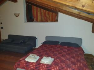 A bed or beds in a room at Mansarda Chanoux CIR n 0027