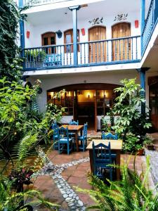 a patio with blue chairs and a table at Doña Esther Otavalo in Otavalo