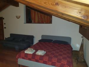 A bed or beds in a room at Mansarda Chanoux CIR n 0027