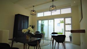 a dining room with a table and chairs and a window at The Executive Bed and Breakfast in East London