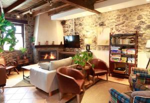 sala de estar con sofá y chimenea en Casa Rural Urkulu Landetxea en Aretxabaleta