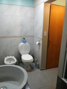 a bathroom with a white toilet and a sink at Alem Casa de Familia in Ushuaia +28 photos