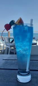 a blue drink sitting on a wooden table at V's studio in Ballito
