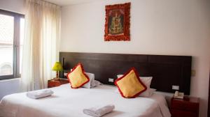 מיטה או מיטות בחדר ב-CHINKANA DEL INKA HOTEL