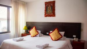 Ліжко або ліжка в номері CHINKANA DEL INKA HOTEL