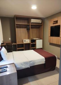 Tempat tidur dalam kamar di Esplanada Brasilia Hotel e Eventos