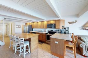 a kitchen with wooden cabinets and a table and chairs at Village West 32 in Ocean City