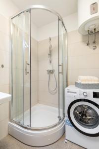 a shower in a bathroom with a washing machine at Diva apartment with free private parking in Split