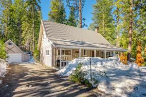 a house in the woods with snow on the ground at Mountain Memories in Shaver Lake
