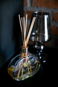 a glass vase with sticks in it on a table at Villagio Santa Tereza in Vacaria