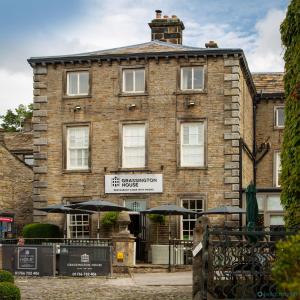 a brick building with umbrellas in front of it at Grassington House in Grassington