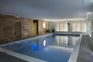 a large swimming pool in a large room at DOMITYS - Les Etoiles d'Argent in Strasbourg