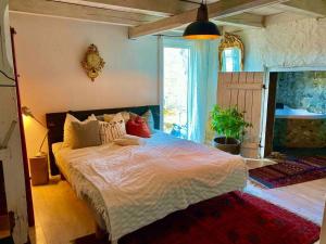 a bedroom with a large bed in a room at Romantic Spa Villa with Fireplace by the lake in Stjärnsund