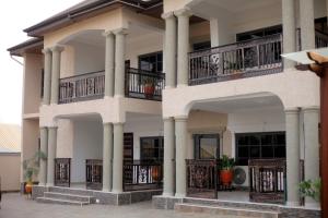 a building with columns and balconies on it at GAD APARTMENTS in Kumasi