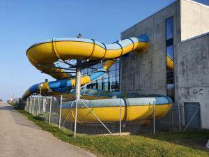 a water slide in front of a building at AnkerZeit - Wellnesswohnung in Damp in Damp
