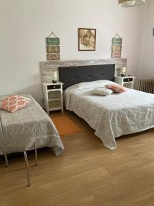 a bedroom with two beds and two night stands at Casa de Campo in Silveiras +38 photos