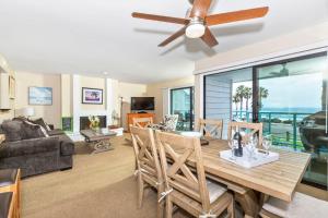 a living room with a dining room table with a ceiling fan at Ocean View with Large Balcony, Air Conditioned in Oceanside