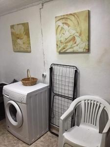 a washing machine and a chair in a room at Casa J Dias in Nordeste