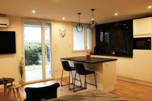 a kitchen with a island with stools in it at O2M Aix les bains in Aix-les-Bains