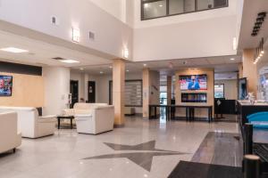 a lobby with a star on the floor at Stars Inn in Leduc