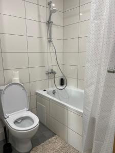 a bathroom with a toilet and a shower with a shower curtain at 0134 Новые смарт апартаменты ЖК «Сады Вишневые» in Vyshneve