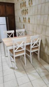 - une table et des chaises blanches dans une cuisine avec une table et des chaises dans l'établissement Casa rural el Burro, à Agüimes