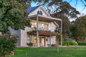 a house with a balcony on the side of it at The Farm Willunga in Willunga