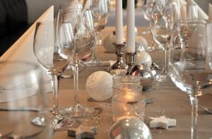 a table with wine glasses and candles on it at Hotel Bodensee-Arena in Kreuzlingen