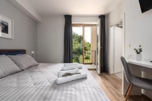 a bedroom with a large white bed and a desk at Vitis Apartment Istra in Tinjan +49 photos