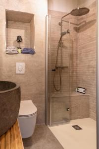 a bathroom with a shower with a toilet and a sink at Gut Leben Landresort in Bernau bei Berlin