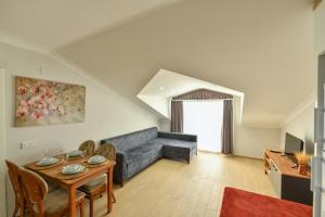 a living room with a couch and a table at Çetkin Exclusive Apart in Fethiye