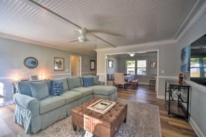 a living room with a couch and a table at Charming House with Patio, 3 half Mi to Beach! in Charleston