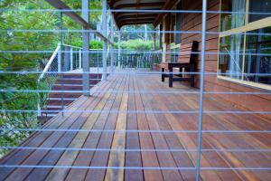a porch with a bench on a house at Ellimata Holiday Cottage in Halls Gap