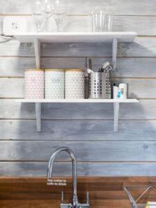 a kitchen counter with a sink and a shelf at Loughview chalet in Whitehouse Lower