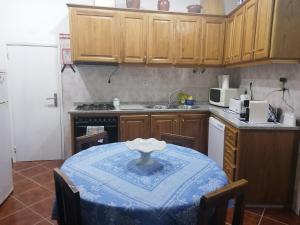eine Küche mit einem Tisch und einem blauen Tischtuch darauf in der Unterkunft Casa do Bonifácio in Vilarinho