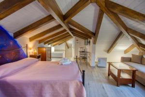 a bedroom with a large bed and a couch at la casa via delle stelle in Agerola