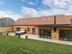 a brick house with a courtyard and a yard at The Gully in Sherborne