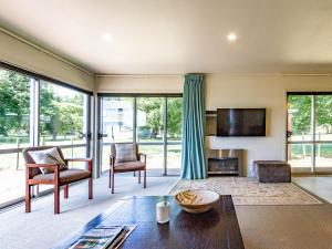 a living room with a fireplace and a tv at Alpine Retreat - Ohakune Holiday Home in Ohakune