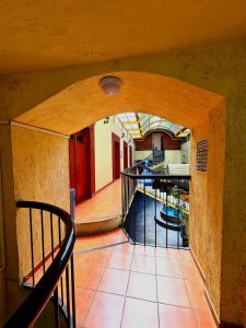 a hallway with an archway in a building at Hotel Centro Historico in Puebla