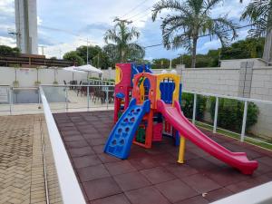a playground with a slide on a patio at APTO, 2 quartos, confortável e bem localizado in Palmas