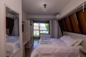 Un pat sau paturi într-o cameră la Pousada Praia da Lagoinha