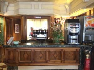 a kitchen with a counter with a microwave and a refrigerator at Hotel Santa Marina in Venice