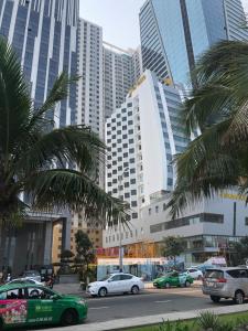 a city with cars and palm trees and tall buildings at My Khe beach apartment hotel, 2 bedrooms in Da Nang